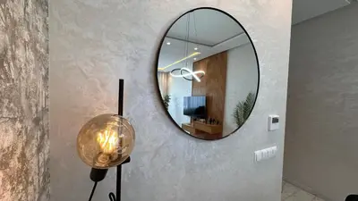 a round mirror on a wall with a lamp at Chic Family Place - by AppartAli in Casablanca