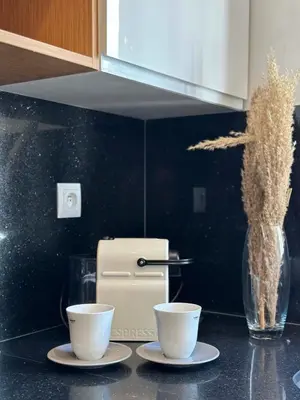 a kitchen counter with two cups and a vase at Chic Family Place - by AppartAli in Casablanca