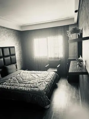 a bedroom with a bed and a table and a window at Ocean Apartments in Casablanca