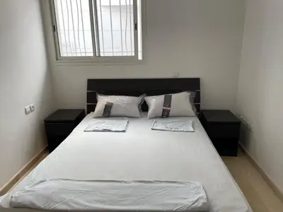 a bedroom with a large bed with white sheets and pillows at Villa pied dans l'eau skhirat in Skhirat