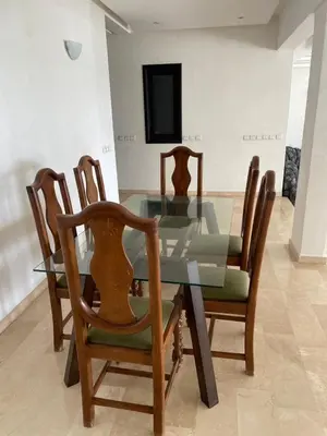 a dining room with a glass table and chairs at Villa pied dans l'eau skhirat in Skhirat
