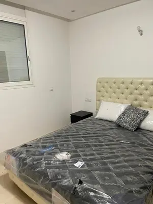 a bedroom with a large bed and a window at Villa pied dans l'eau skhirat in Skhirat