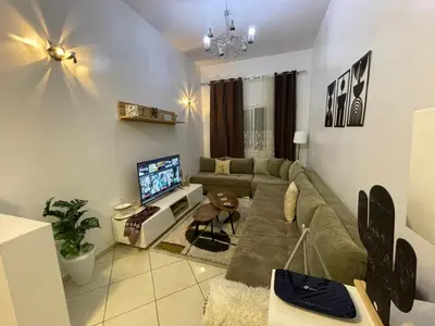 a living room with a couch and a tv at Chez vous à Skhirate in Skhirat