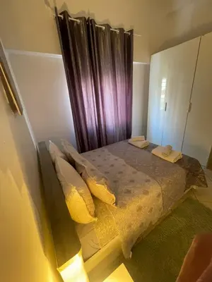 a bedroom with a bed with yellow pillows at Chez vous à Skhirate in Skhirat