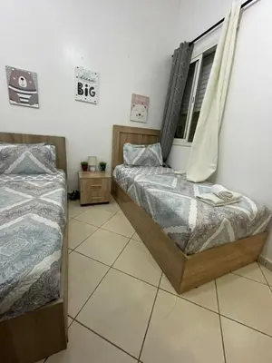 a bedroom with two beds and a window at Chez vous à Skhirate in Skhirat