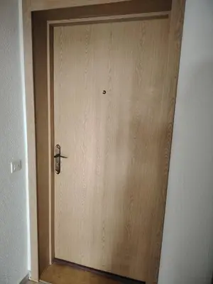a wooden door with a handle in a hallway at Chez vous à Skhirate in Skhirat