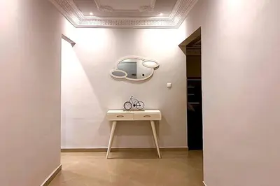 a room with a table and a mirror on the wall at Elegant appartement de 2 chambres sur bd Anfa in Casablanca