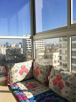 a couch sitting in front of a large window at Elegant appartement de 2 chambres sur bd Anfa in Casablanca