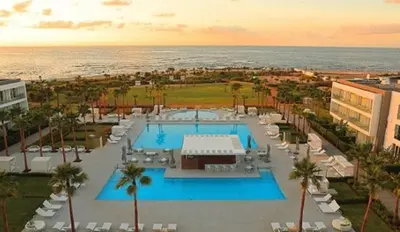 an aerial view of a resort with a pool and the ocean at Appartement de Luxe à Bahia Golf Beach Spacieux de 126 m in Bouznika