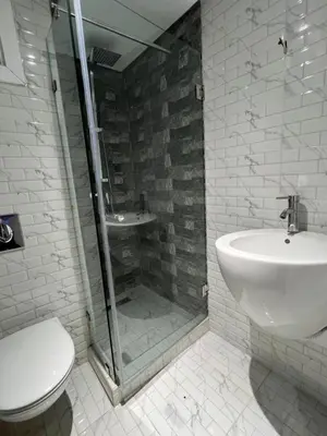 a bathroom with a shower and a toilet and a sink at Appartement de Luxe à Bahia Golf Beach Spacieux de 126 m in Bouznika