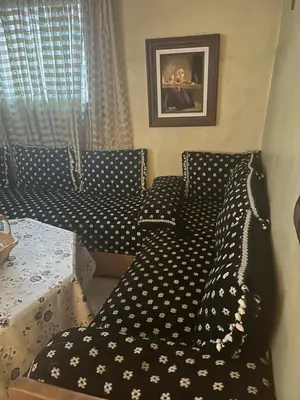 a couch with polka dot pillows in a room at Charmant appartement in Casablanca