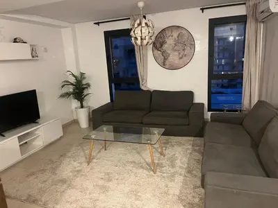 a living room with a couch and a coffee table at Appartement Casa Finance City in Casablanca