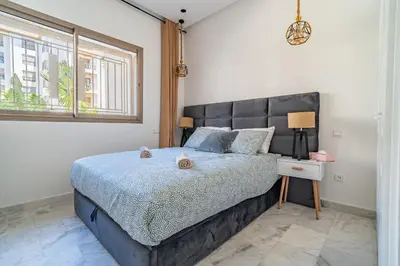 a bedroom with a large bed and a window at AeroStay in Nouaceur