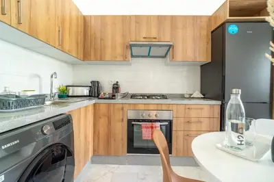 a kitchen with a stove and a dishwasher at AeroStay in Nouaceur