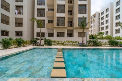 a swimming pool in front of a building at AeroStay in Nouaceur