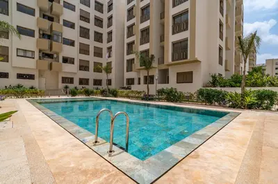 a swimming pool in front of a building at AeroStay in Nouaceur