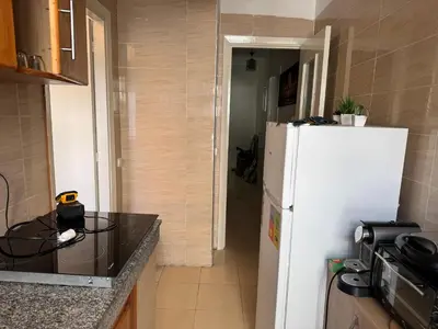 a kitchen with a white refrigerator and a hallway at Garsoniere Borj in Rabat