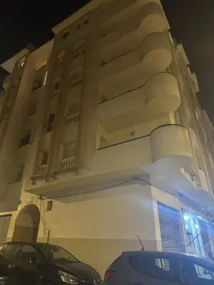 a building with cars parked in front of it at Garsoniere Borj in Rabat