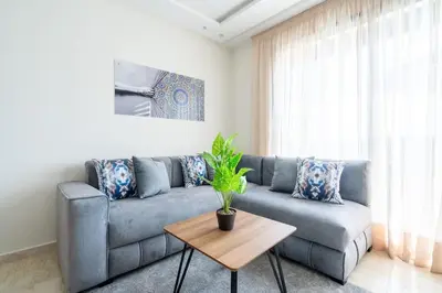 a living room with a blue couch and a table at Superbe appartement à Casablanca in Casablanca