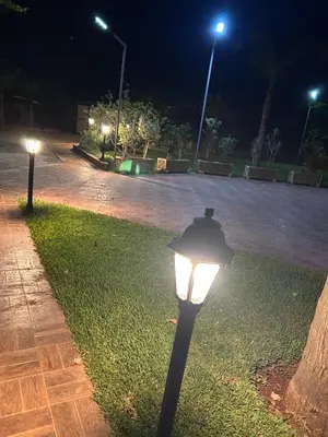 a street light in a park at night at Villa Ines avec piscine privée in Sidi Moussa Ben Ali