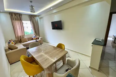 a living room with a wooden table and chairs at Séjour confortable, Plage Skhirat in Skhirat