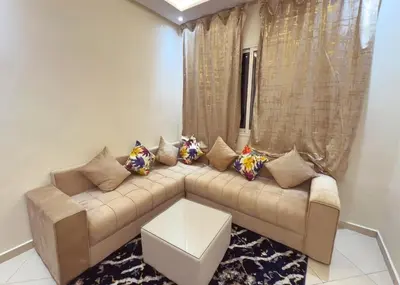 a living room with a couch with pillows at Séjour confortable, Plage Skhirat in Skhirat