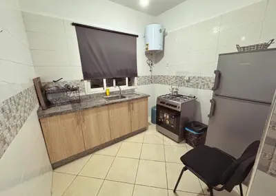 a kitchen with a tv and a stove and a refrigerator at Séjour confortable, Plage Skhirat in Skhirat
