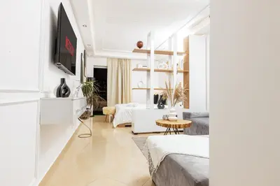 a living room with a couch and a tv at Luxury 1BR with Charming Balcony - Romantic Getaway in Rabat