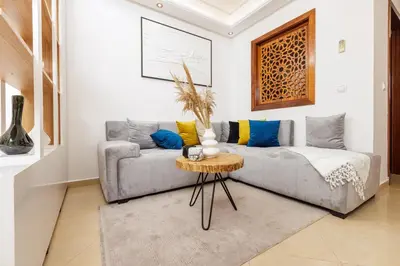 a living room with a couch and a table at Luxury 1BR with Charming Balcony - Romantic Getaway in Rabat
