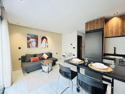 a living room with a couch and a table at Oasis 9 Cozy studio in Downtown Maarif in Casablanca