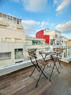 a table and chairs on the roof of a building at Oasis 9 Cozy studio in Downtown Maarif in Casablanca
