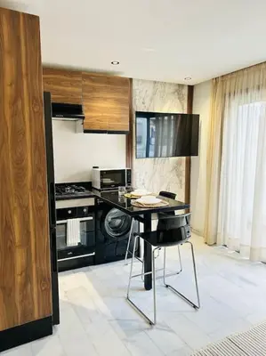 a kitchen with a table and a stove at Oasis 9 Cozy studio in Downtown Maarif in Casablanca