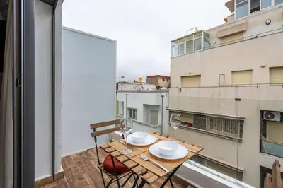 a balcony with a table and chairs and a window at Oasis 9 Cozy studio in Downtown Maarif in Casablanca