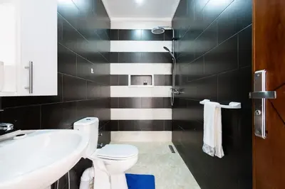 a bathroom with a white toilet and a sink at Appartement Proche Plage in Bouznika