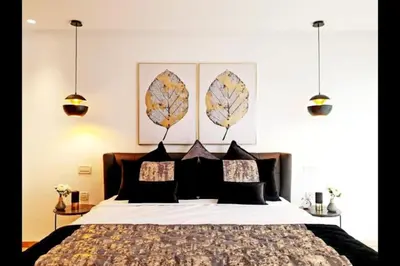 a bedroom with a large bed with leaves on the wall at Marina Ocean Suite - By Appart'Ayla in Casablanca