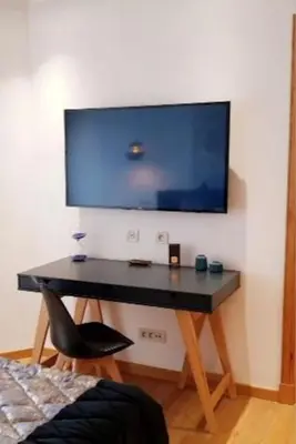a black desk with a television on a wall at Marina Ocean Suite - By Appart'Ayla in Casablanca
