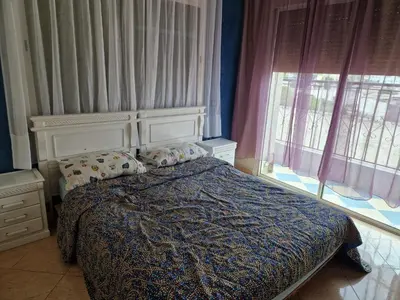 a bedroom with a bed and a large window at Élégance et Confort à Ain Sebaa, Commodité,Plages in Casablanca
