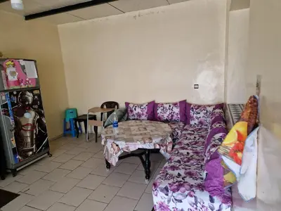 a living room with a couch and a table at Élégance et Confort à Ain Sebaa, Commodité,Plages in Casablanca