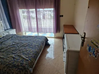 a bedroom with a bed and a refrigerator and a window at Élégance et Confort à Ain Sebaa, Commodité,Plages in Casablanca