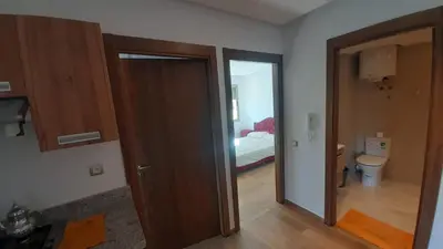 a room with a door leading to a bedroom at blue beach in Sidi Rahal