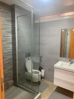 a bathroom with a toilet and a glass shower at Villa avec piscine Mohammedia in Mohammedia