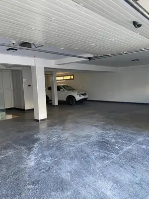 a garage with a white car parked in it at Villa avec piscine Mohammedia in Mohammedia