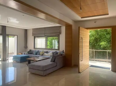 a living room with a couch and a table at Villa avec piscine Mohammedia in Mohammedia