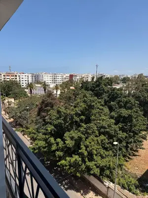 a view of a city from a balcony at Luxury studio center Abdelmoumen 1min tram with view in Casablanca