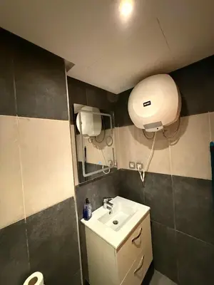 a bathroom with a sink and a mirror at Luxury studio center Abdelmoumen 1min tram with view in Casablanca