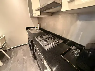 a kitchen with a stove and a counter top at Luxury studio center Abdelmoumen 1min tram with view in Casablanca