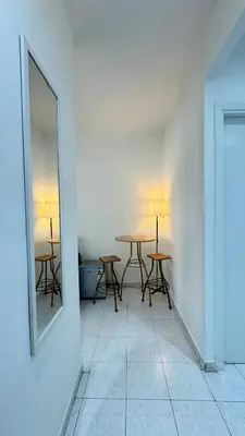 a room with two tables and a mirror on the wall at SUITOUISS - Agdal - Studio en plein cœur de Rabat à 5 minutes du grand mall Arribat Center - centre ville in Rabat