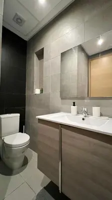 a bathroom with a toilet and a sink at Prestigia Hay Riad, Appartement Moderne au Style Chic in Rabat