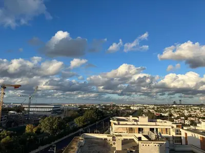a view of a city under a cloudy sky at Prestigia Hay Riad, Appartement Moderne au Style Chic in Rabat