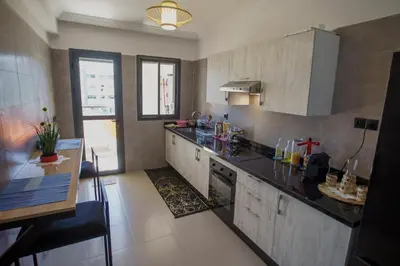 a kitchen with a counter top and a sink at Relax toute l'année Piscine chauffée in Temara